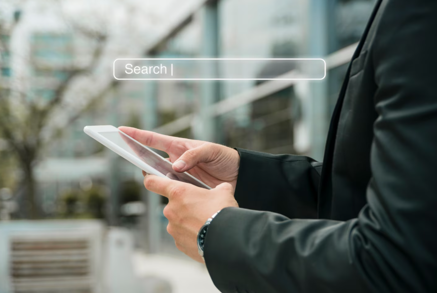 Person using a phone to search after a tech launch reflecting post-launch search phrase behavior.