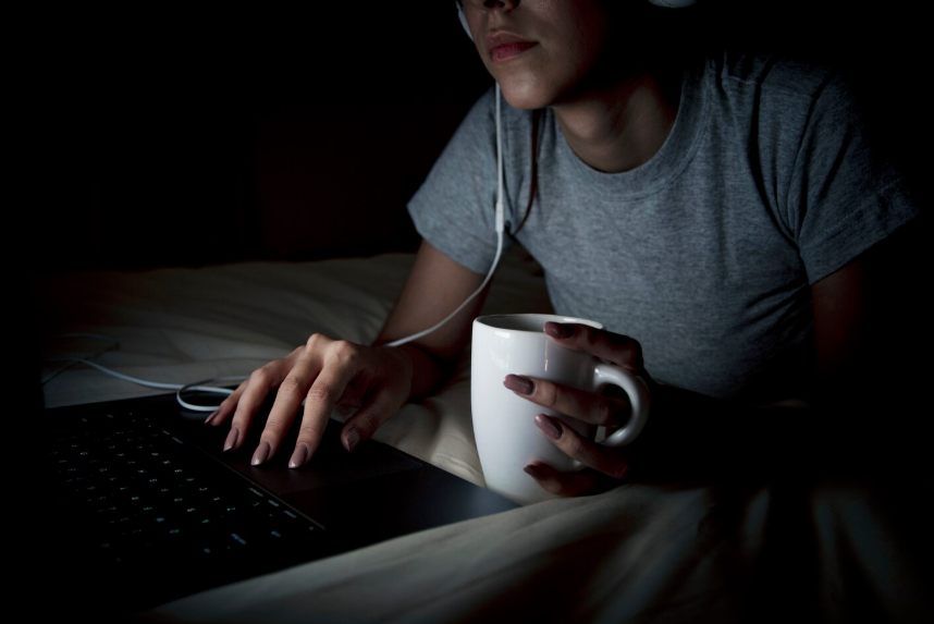 Person searching online late at night, reflecting how to disappear searches driven by overwhelm.